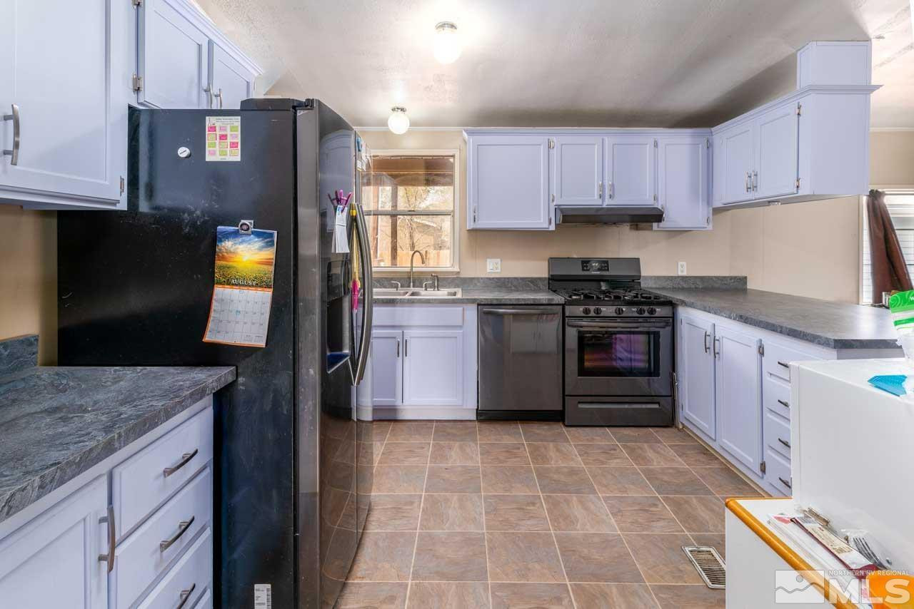 17500 Thrush Lane Reno, NV 89508 - Photo 4 of 18 a kitchen with stainless steel appliances granite countertop a stove a sink and a refrigerator