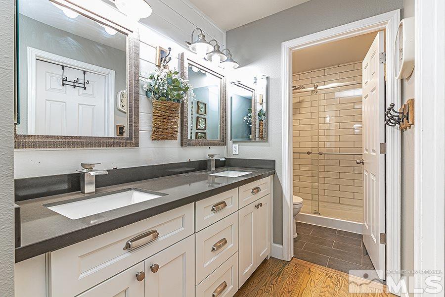 14545 Ghost Rider Drive Reno, NV 89511 - Photo 12 of 24 a bathroom with a granite countertop sink and a mirror