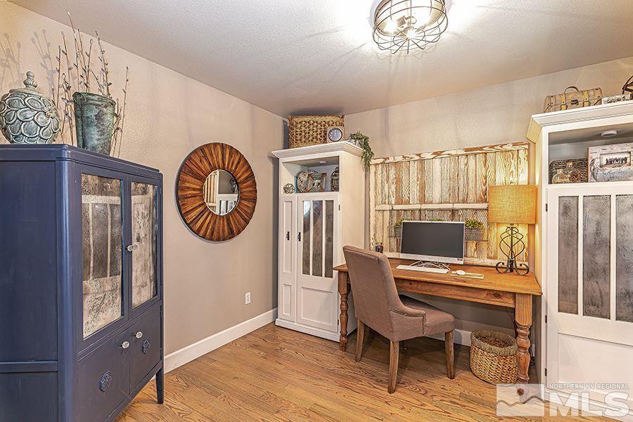 14545 Ghost Rider Drive Reno, NV 89511 - Photo 14 of 24 a living room with furniture a fireplace and a flat screen tv