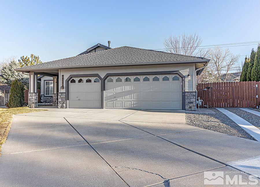 14545 Ghost Rider Drive Reno, NV 89511 - Photo 2 of 24 a front view of a house with a yard and garage