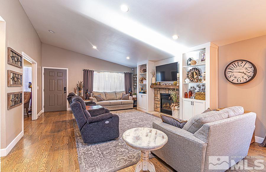 14545 Ghost Rider Drive Reno, NV 89511 - Photo 4 of 24 a living room with furniture a fireplace and a flat screen tv