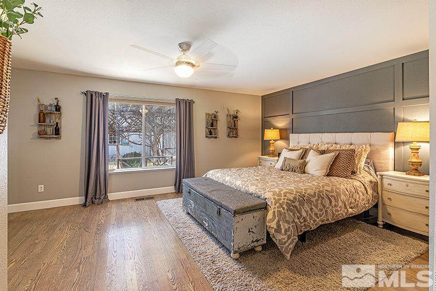 14545 Ghost Rider Drive Reno, NV 89511 - Photo 10 of 24 a spacious bedroom with a bed and a window