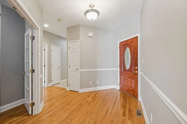 a spacious bathroom with a tub double sink and mirror