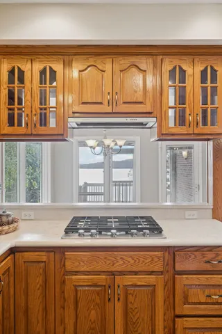 a bathroom with a granite countertop sink toilet a large mirror a shower and a bathtub