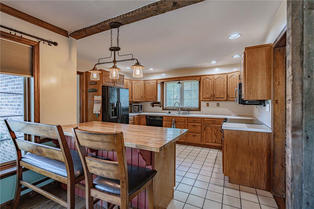 652 Old State Road Oley, PA 19547 - Photo 14 of 54 A warm and inviting kitchen showcases a breakfast bar and ample wood cabinetry.