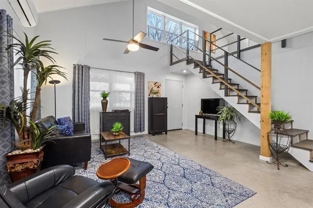 a living room with furniture and a potted plant