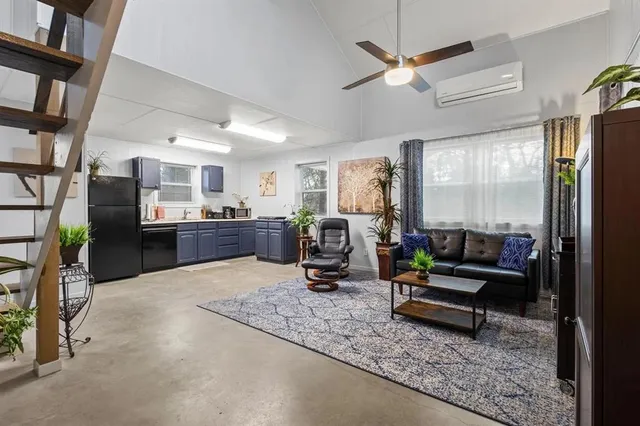 a living room with furniture a flat screen tv and a table