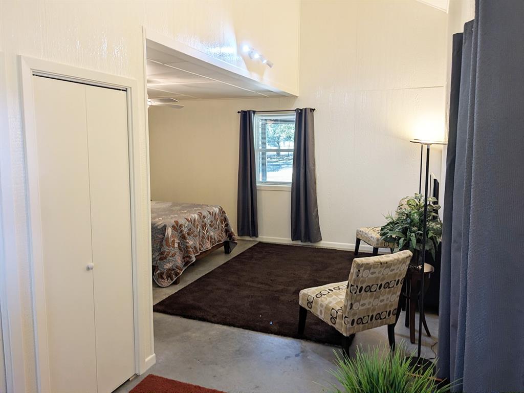 5019 North State Highway Bonham, TX 75418 - Photo 22 of 28 a bedroom with a bed and a dresser