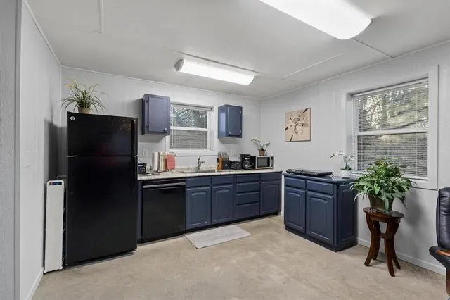 a kitchen with stainless steel appliances granite countertop a refrigerator and a sink