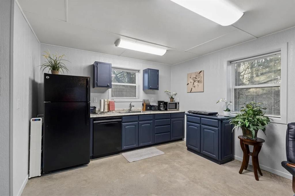5019 North State Highway Bonham, TX 75418 - Photo 10 of 28 a kitchen with stainless steel appliances granite countertop a refrigerator and a sink