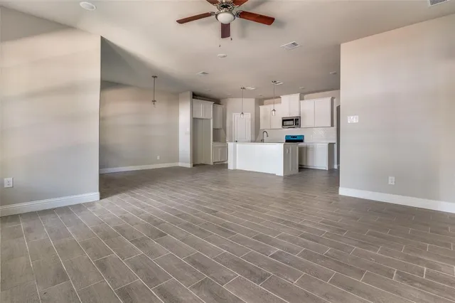 a view of a kitchen with a sink and a refrigerator