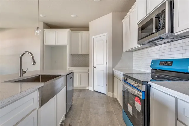 a kitchen with stainless steel appliances granite countertop a stove and a sink