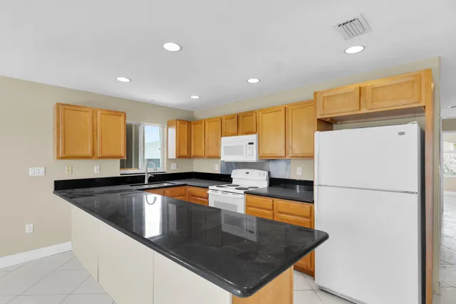 a view of a livingroom with a chandelier fan and closet area