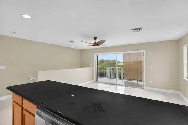 a bathroom with a granite countertop sink a toilet and shower