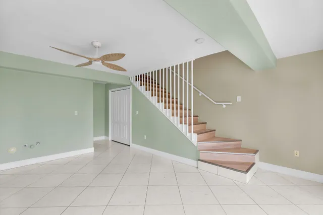 a large kitchen with stainless steel appliances kitchen island granite countertop a refrigerator and a stove top oven