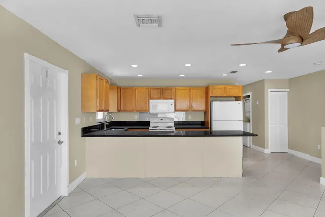 a view of a livingroom with a ceiling fan and window