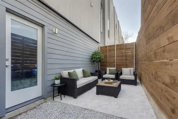 a patio with patio couch and a potted plant