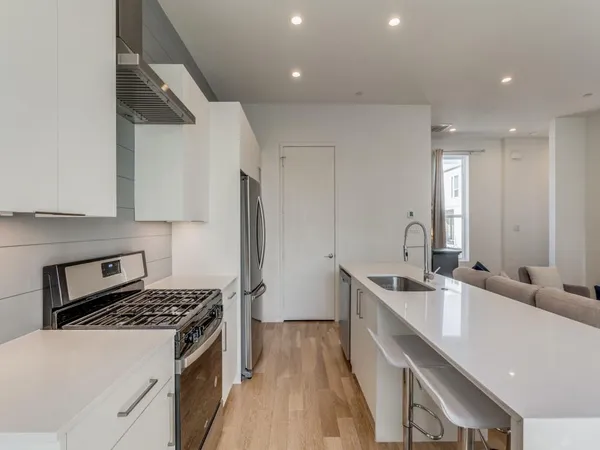 a kitchen with a sink stove and refrigerator