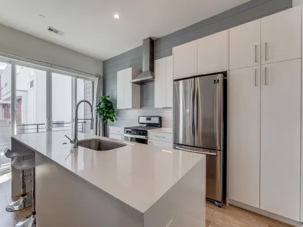 a kitchen with refrigerator a sink and cabinets