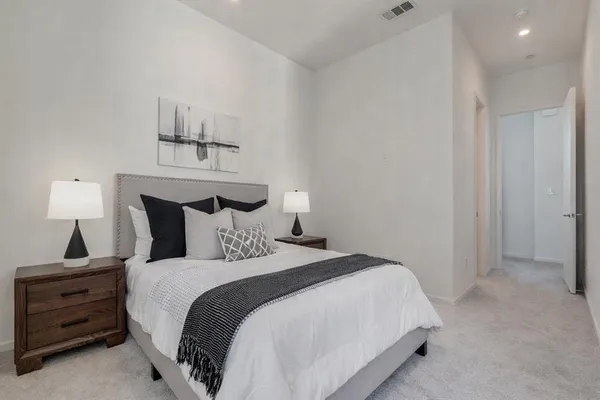 a bed room with a bed and a night stand