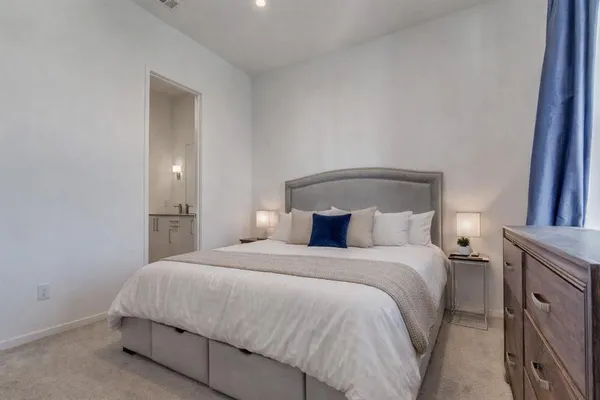 a bedroom with a bed and a mirror