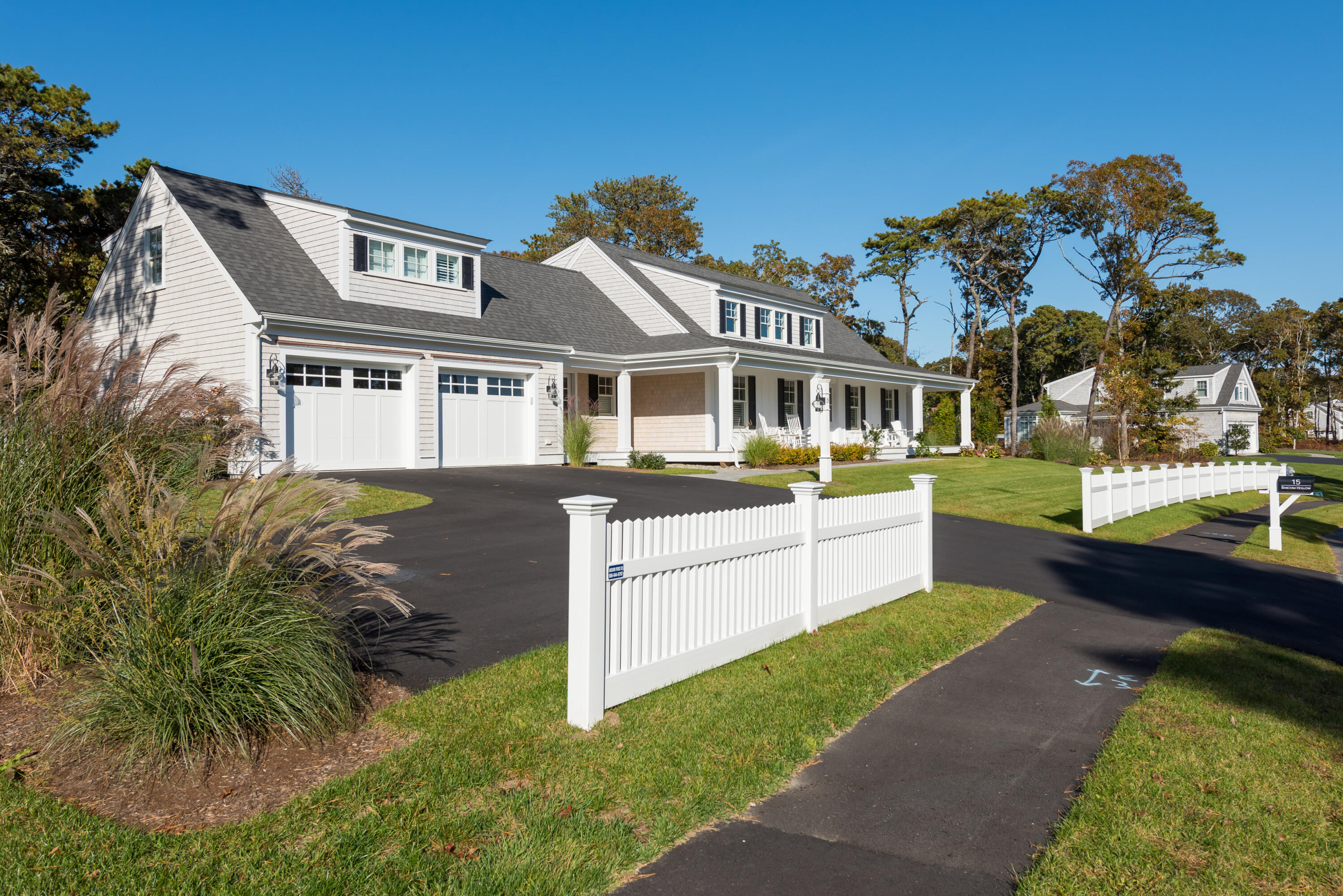 15 Bascom Hollow Harwich, MA 02645 - Photo 1 of 35 a front view of a house with a yard table and chairs