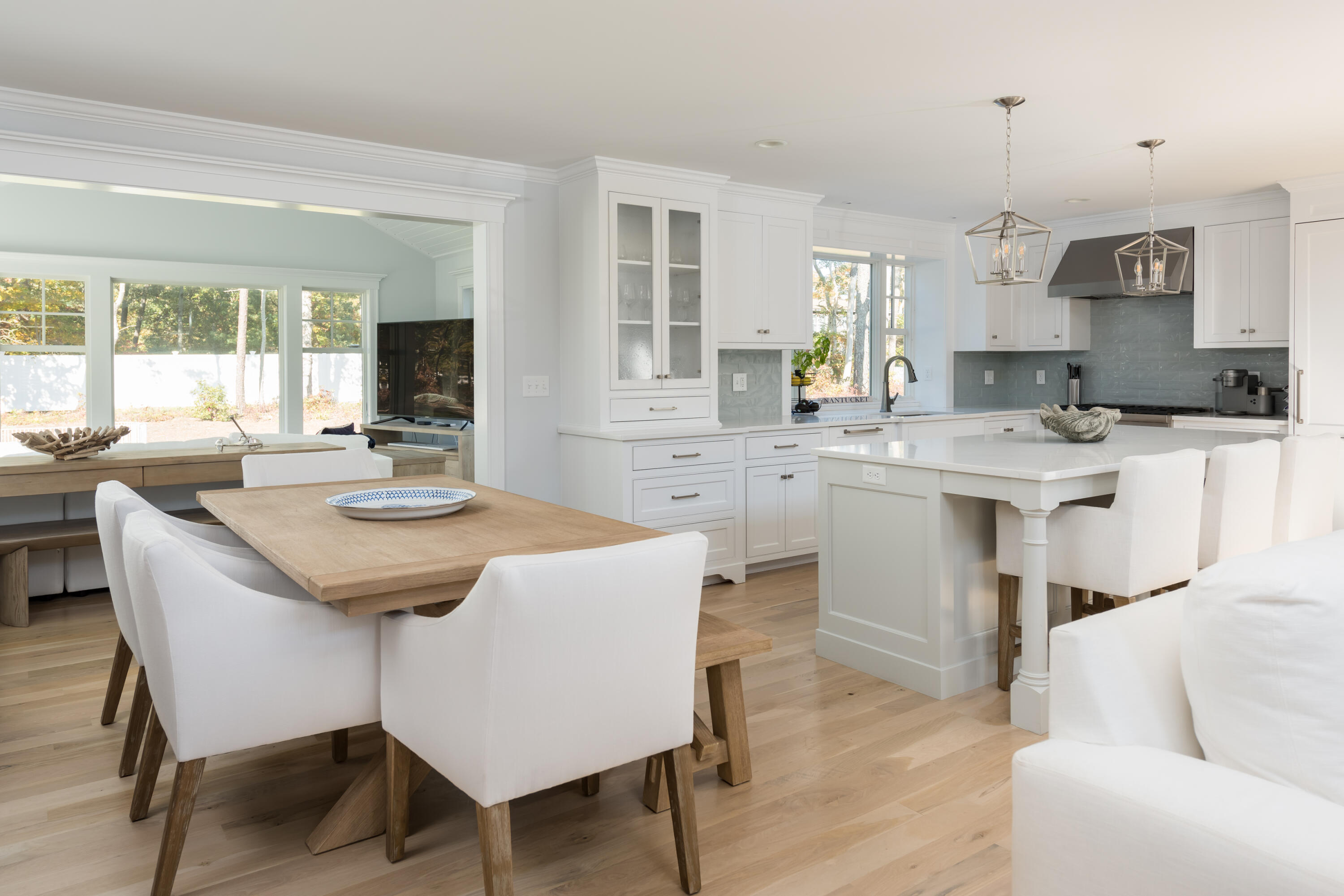 15 Bascom Hollow Harwich, MA 02645 - Photo 17 of 35 a kitchen with a dining table chairs and white cabinets