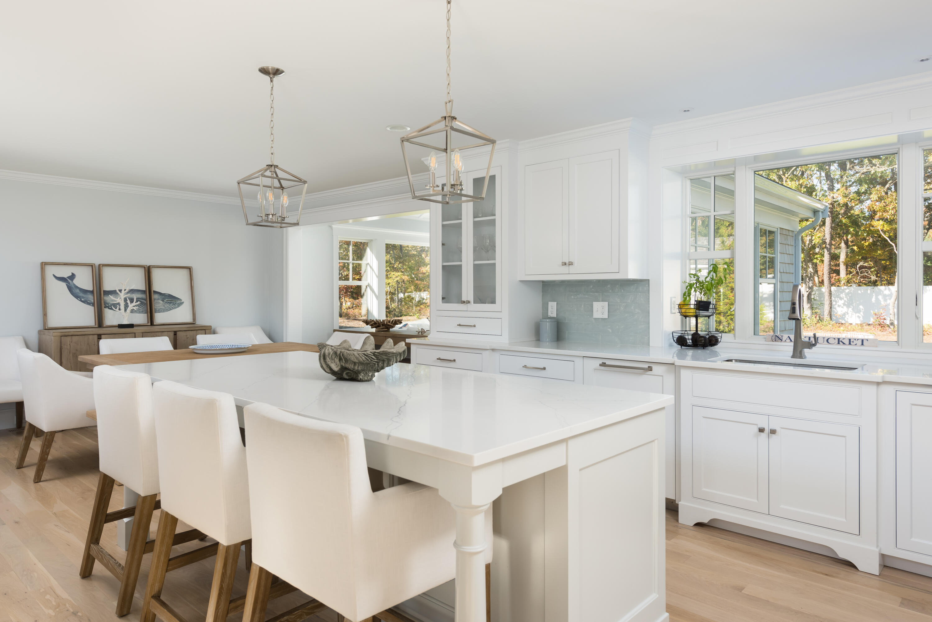 15 Bascom Hollow Harwich, MA 02645 - Photo 18 of 35 a kitchen with a dining table chairs and white cabinets