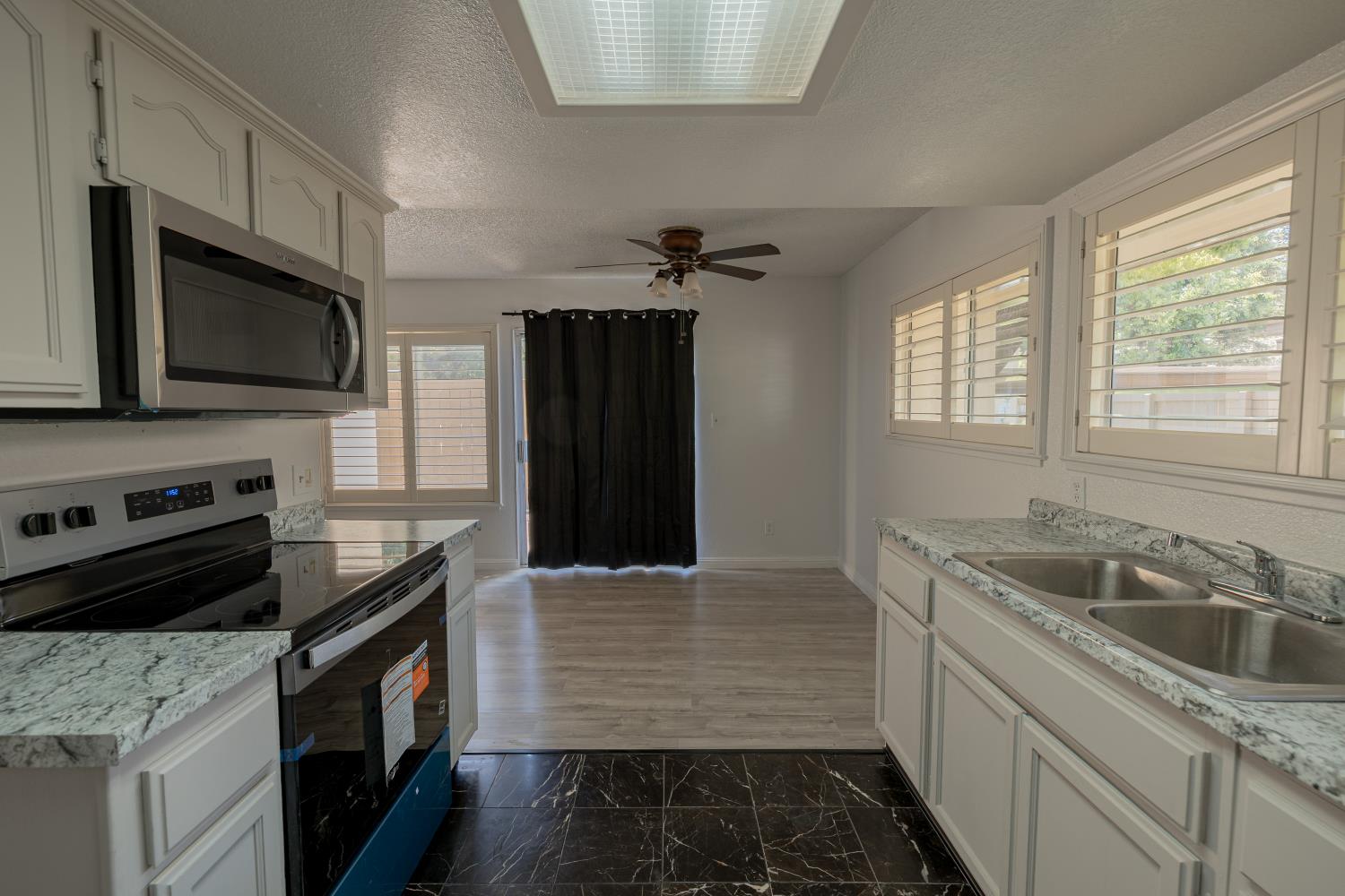 3700 Tully Road, Unit 5 Modesto, CA 95356 - Photo 11 of 38 a kitchen with a sink stove and microwave