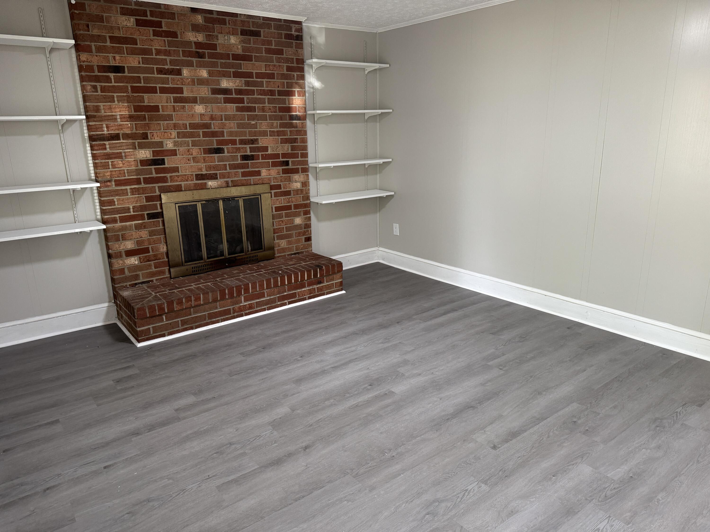 136 Nelson Avenue Danville, VA 24540 - Photo 2 of 7 a room with wooden floor and a fireplace
