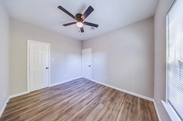 wooden floor in an empty room with a window