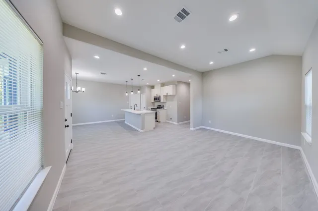 a view of kitchen with a sink and a refrigerator