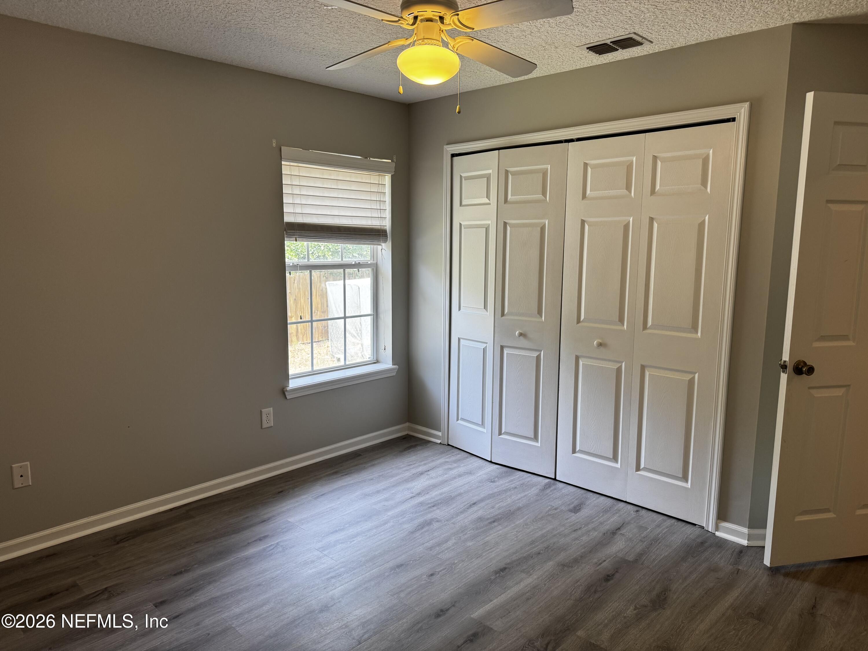 16255 Shellcracker Road Jacksonville, FL 32226 - Photo 23 of 40 a view of an empty room with window and wooden floor