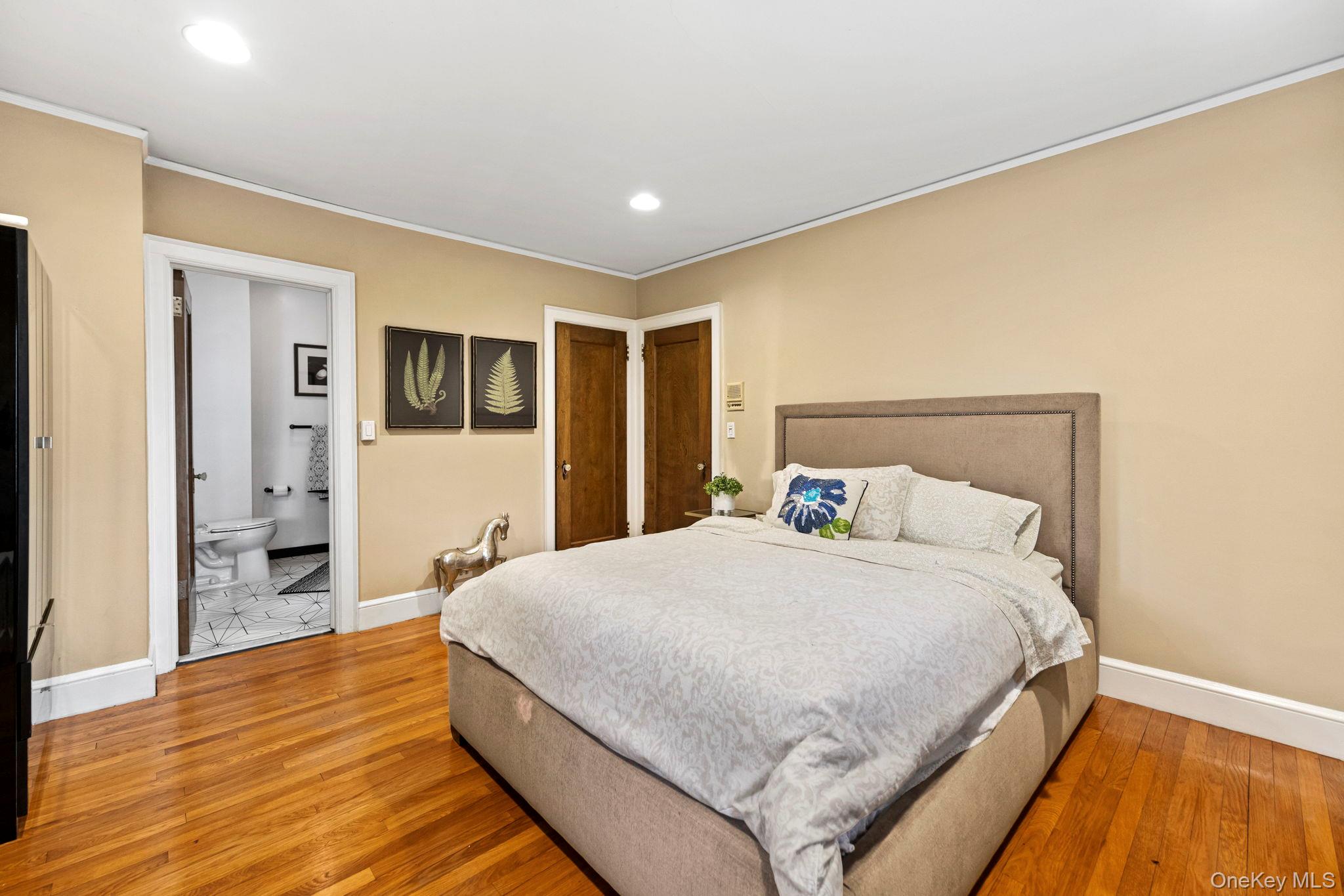 44 Fenimore Road New Rochelle, NY 10804 - Photo 27 of 46 a spacious bedroom with a bed and a dresser