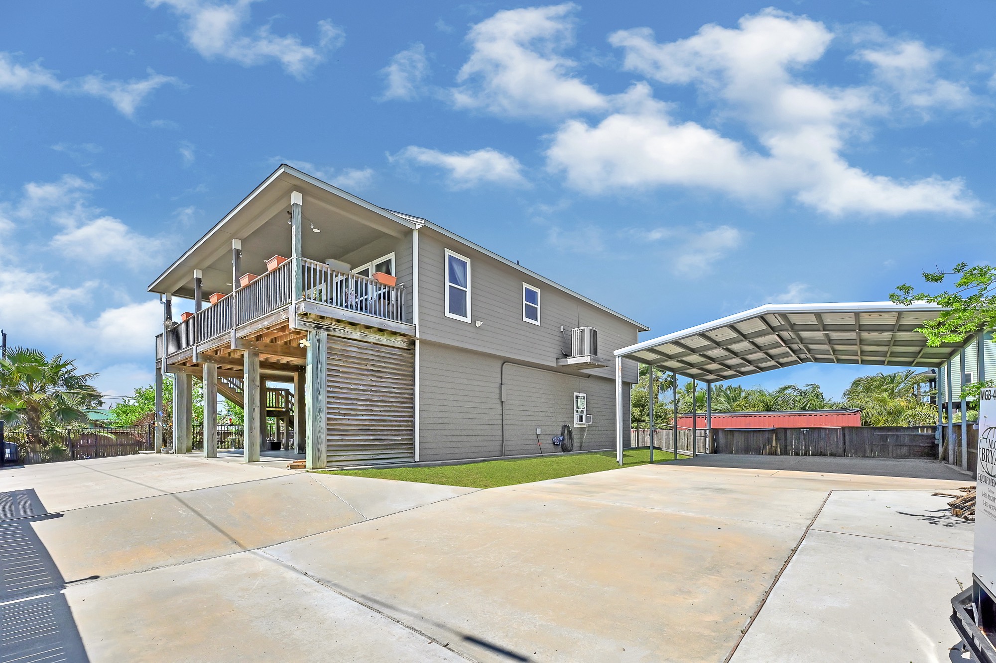 939 8th Street Dickinson, TX 77539 - Photo 5 of 31 This elevated home features a spacious second-story deck and a large covered carport, perfect for coastal living. The ample driveway offers additional parking, and the yard is well-maintained. Ideal for enjoying outdoor activities and entertaining.
