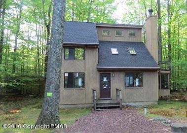 230 Selig Road Pocono Lake, PA 18347 - Photo 1 of 20 a front view of a house with a garden