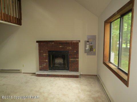230 Selig Road Pocono Lake, PA 18347 - Photo 5 of 20 a view of an empty room with a fireplace and a window