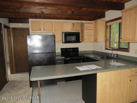 230 Selig Road Pocono Lake, PA 18347 - Photo 8 of 20 a kitchen with stainless steel appliances a microwave a sink and a refrigerator