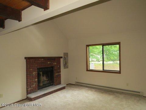 230 Selig Road Pocono Lake, PA 18347 - Photo 10 of 20 a view of an empty room with a fireplace and a window
