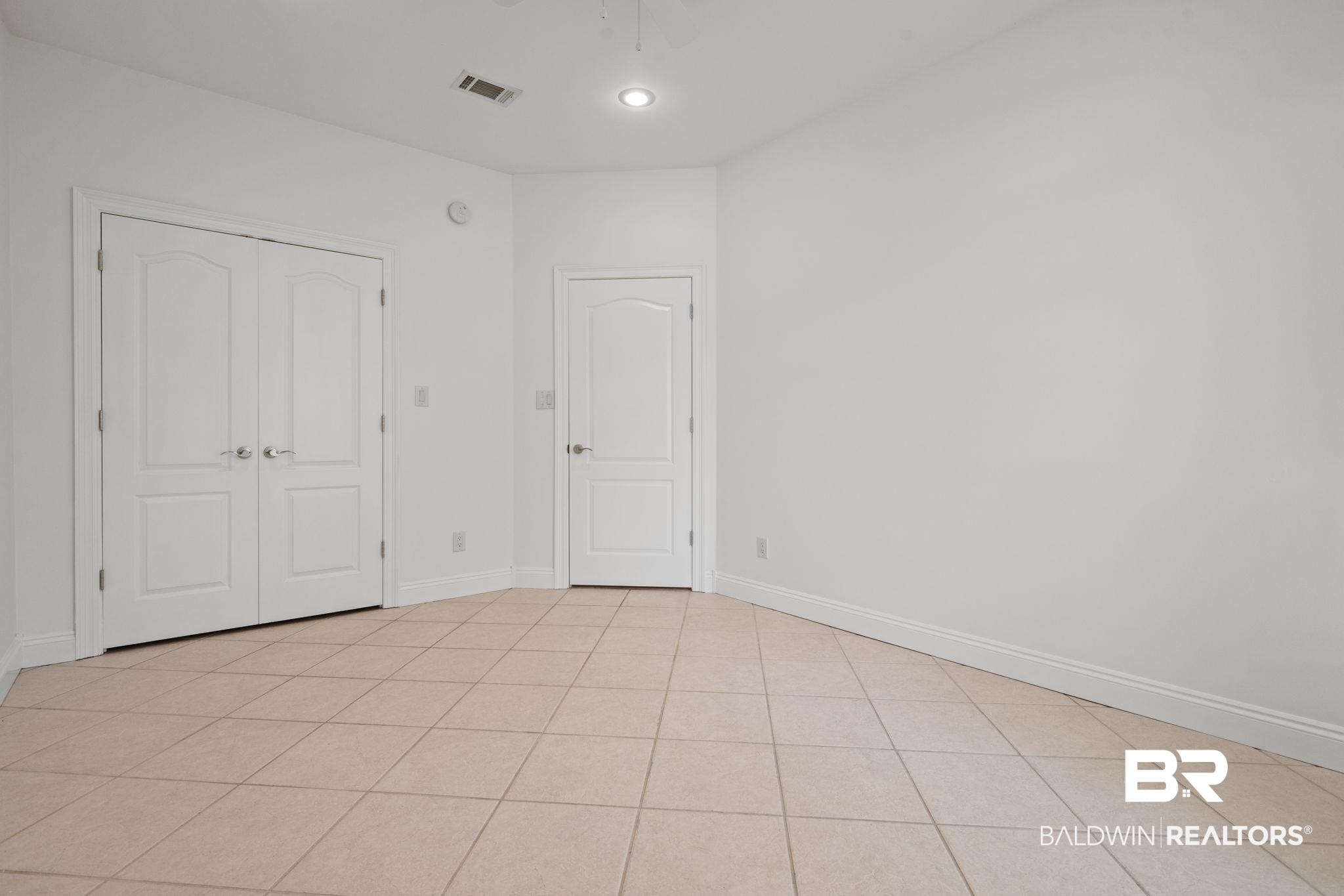29634 St George Street Daphne, AL 36526 - Photo 29 of 47 Unfurnished bedroom with a closet, light tile patterned floors, and recessed lighting