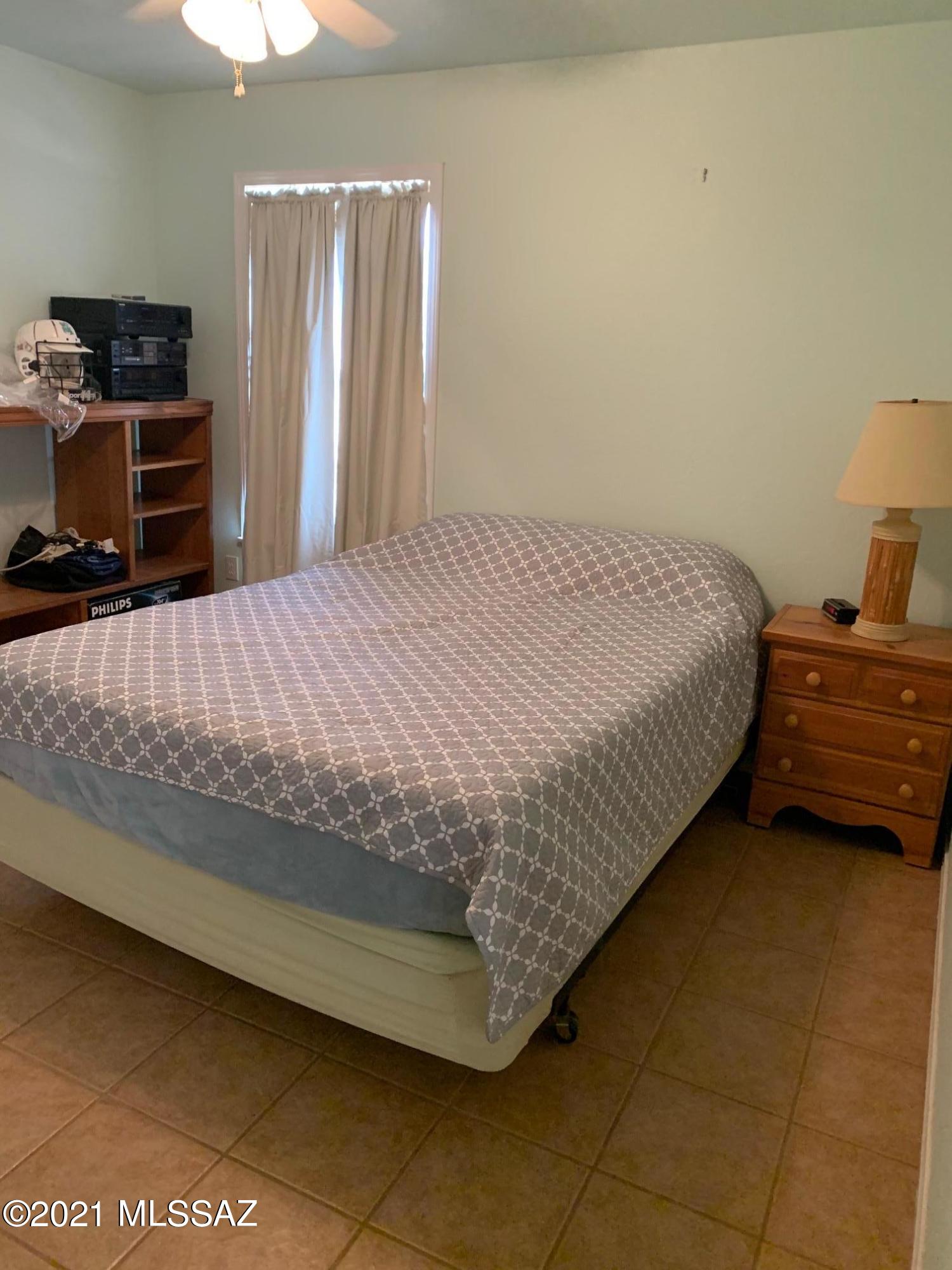 3504 East Howling Wolf Road Willcox, AZ 85643 - Photo 16 of 21 a bedroom with a bed and dresser