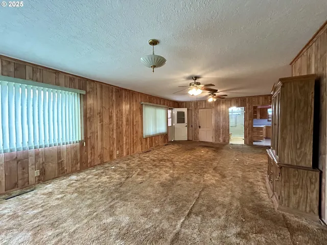 a kitchen with a stove a sink a window and stainless steel appliances