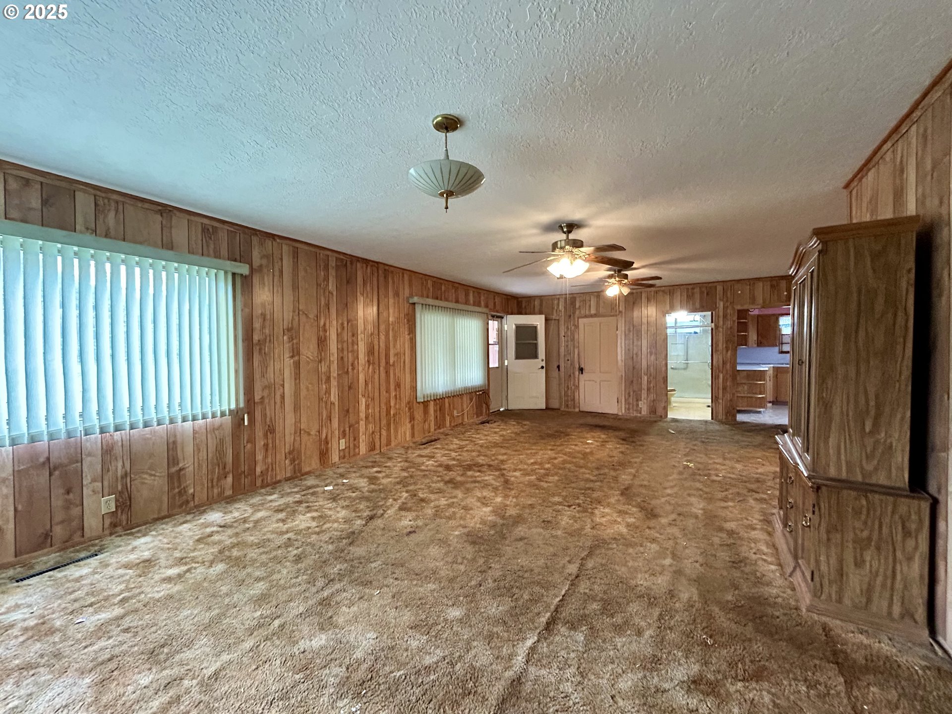 823 West 8th Street The Dalles, OR 97058 - Photo 11 of 20 a view of a livingroom with a chandelier fan and windows