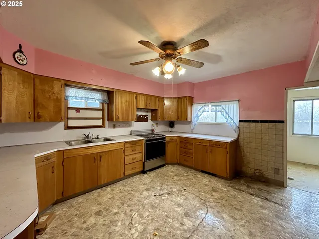 a large kitchen with a sink and cabinets