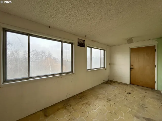 a view of an empty room with a fireplace