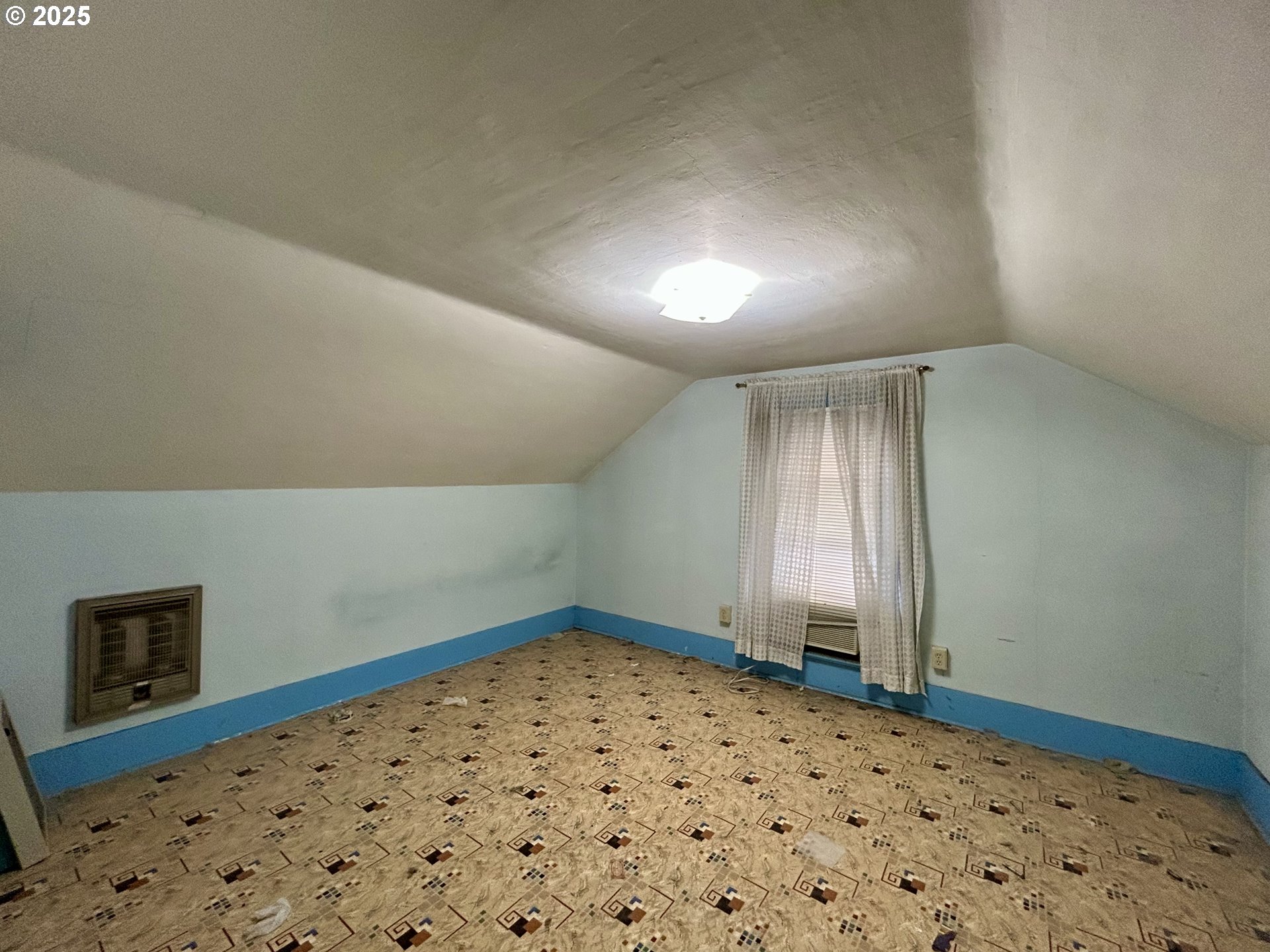 823 West 8th Street The Dalles, OR 97058 - Photo 16 of 20 a bedroom with a bed and a window