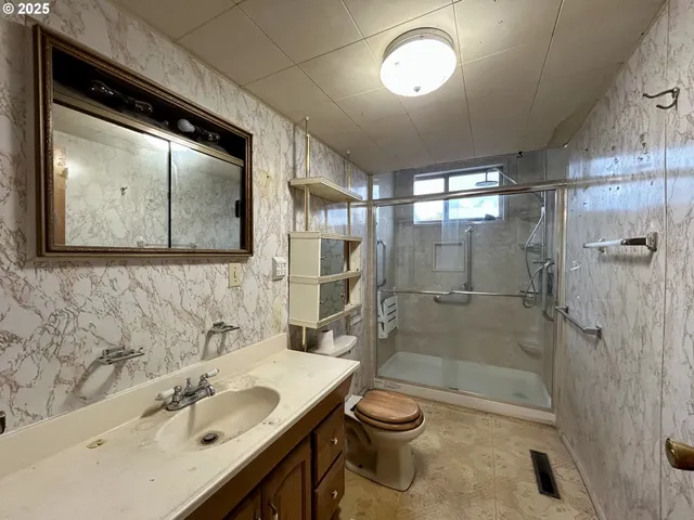 a bathroom with a sink toilet and shower