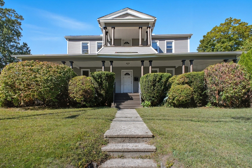 941 Allen Street Springfield, MA 01118 - Photo 1 of 28 a front view of a house with a garden