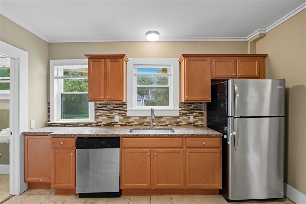 941 Allen Street Springfield, MA 01118 - Photo 3 of 28 a kitchen with stainless steel appliances granite countertop a refrigerator and a sink