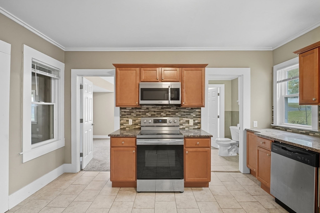 941 Allen Street Springfield, MA 01118 - Photo 4 of 28 a kitchen with stainless steel appliances granite countertop a stove and a sink